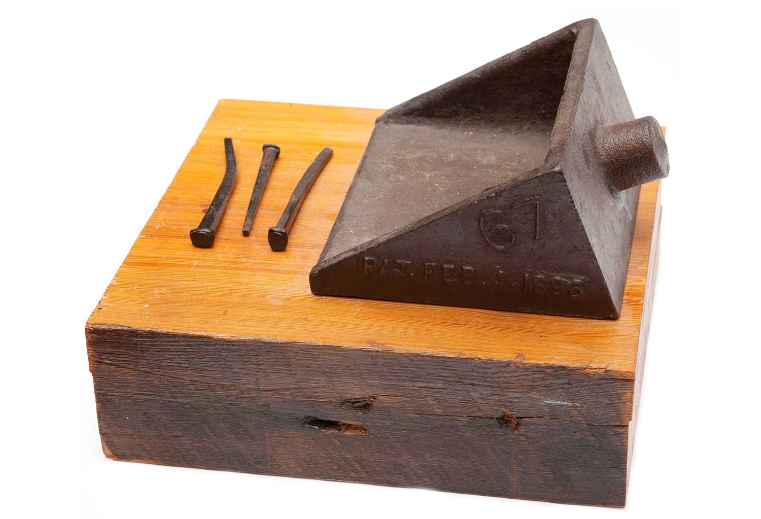 A wood block, metal nails, and triangular metal bracket.