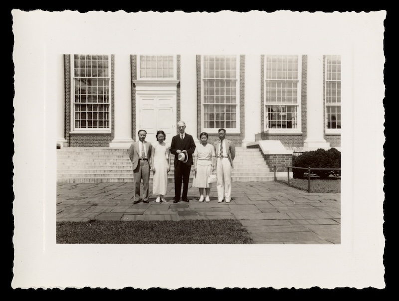 A black-and-white photo of five individuals standing in front of UVA's main library.