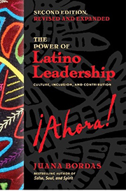 The cover of a book titled "The Power of Latino Leadership: Culture, Inclusion, and Contribution" by Juana Bordas. The title "¡Ahora!" is highlighted in bold red text. The left side of the cover features vibrant, multicolored fabric designs, while the right side has a black background with abstract patterns in dark gray. Juana Bordas is noted as the bestselling author of "Salsa, Soul, and Spirit."