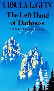 Book cover of "The Left Hand of Darkness" by Ursula K. Le Guin, featuring an illustration of a snowy mountain landscape with a castle and a figure walking towards it. The text is predominantly in white against a blue background.