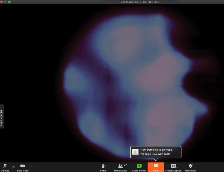             Screenshot of a Zoom shared screen, which shows a work of art by Yo-Yo Lin. The art is a white and grey blob against a black background. The top of the screen names the Zoom Meeting. The bottom shows a series of grey buttons, along with an orange chat button that is lit up. A speech bubble above it "From Dominika to everyone" says "yes same issue with audio."