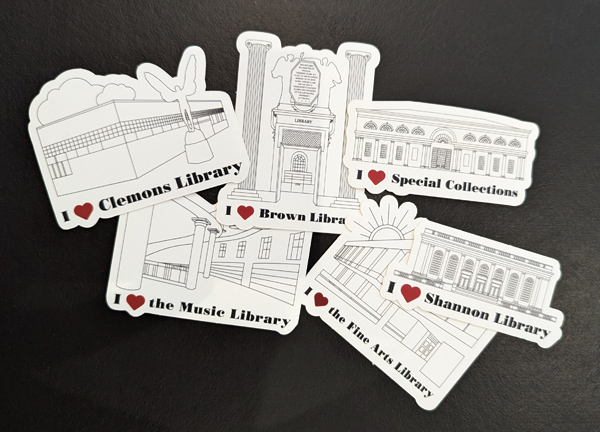 The image shows a collection of six stickers, each featuring a line drawing of a different library or library section with the text "I ♥" followed by the library's name. The libraries are:      Clemons Library     Brown Library     Special Collections     The Music Library     Shannon Library     The Fine Arts Library  Each sticker includes a simple architectural illustration of the corresponding library, along with the phrase "I ♥" and the name of the library below the drawing. The stickers are arranged in a scattered layout on a dark background.