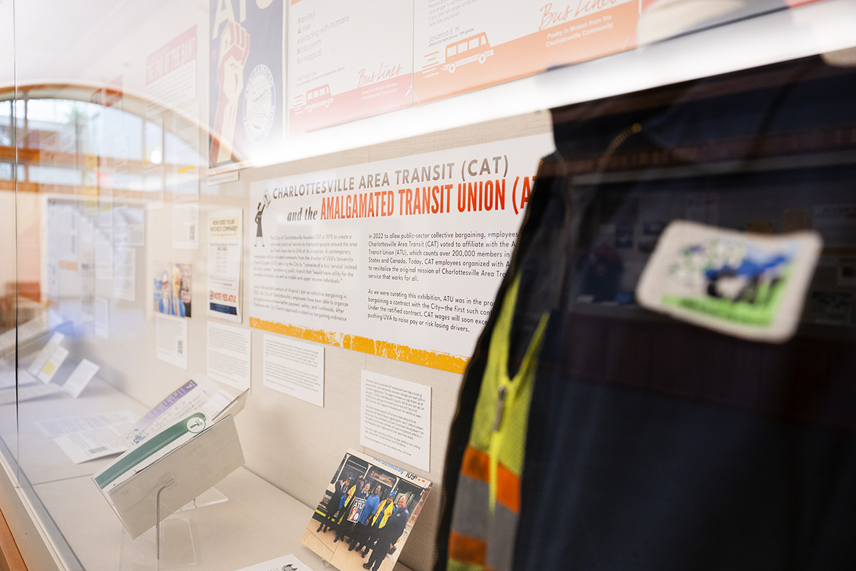 A photo of the exhibition case showing a transit worker vest, photo of the union, and information about their recent organizing.