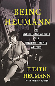 Book cover of "Being Heumann," featuring a black-and-white photo of Judith Heumann (a white, middle-aged woman) in a wheelchair.