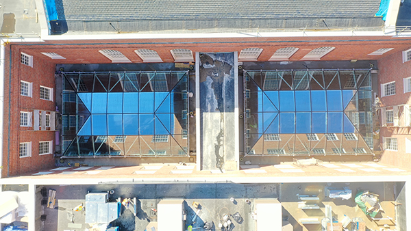 A few of a building from above. Faceted windows in sunken openings are visible.