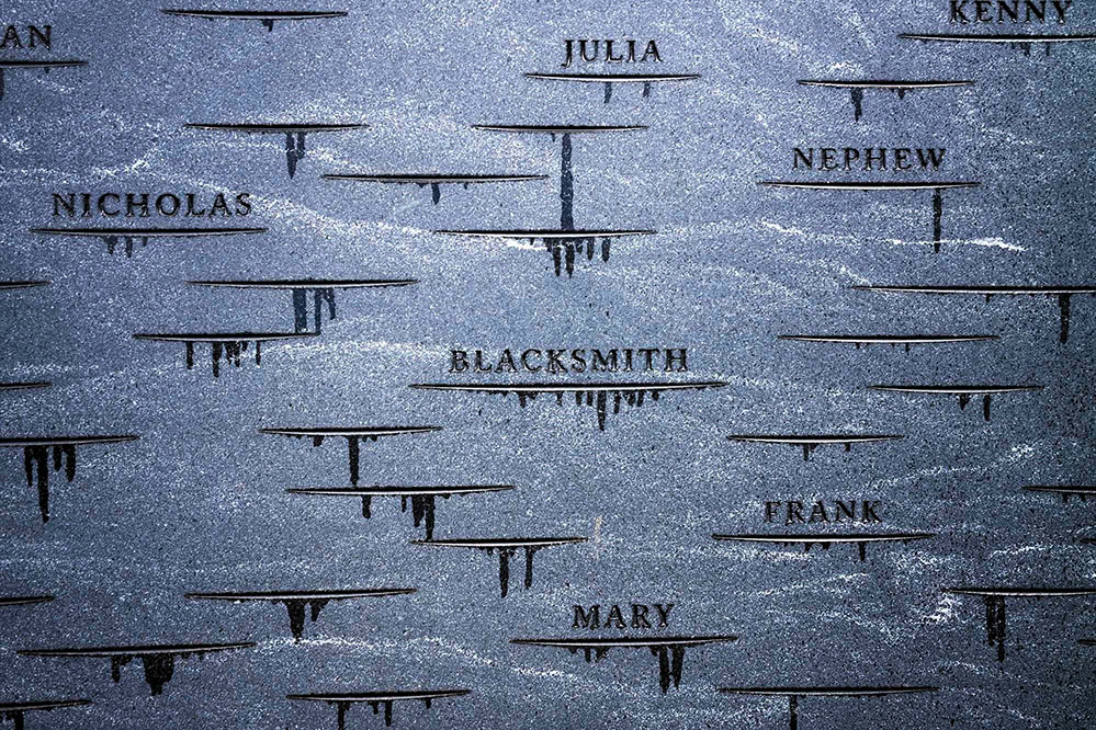 Identifying marks etched into granite: names, occupations, and horizontal lines that recognize the as-yet-unnamed enslaved laborers who worked in the University.
