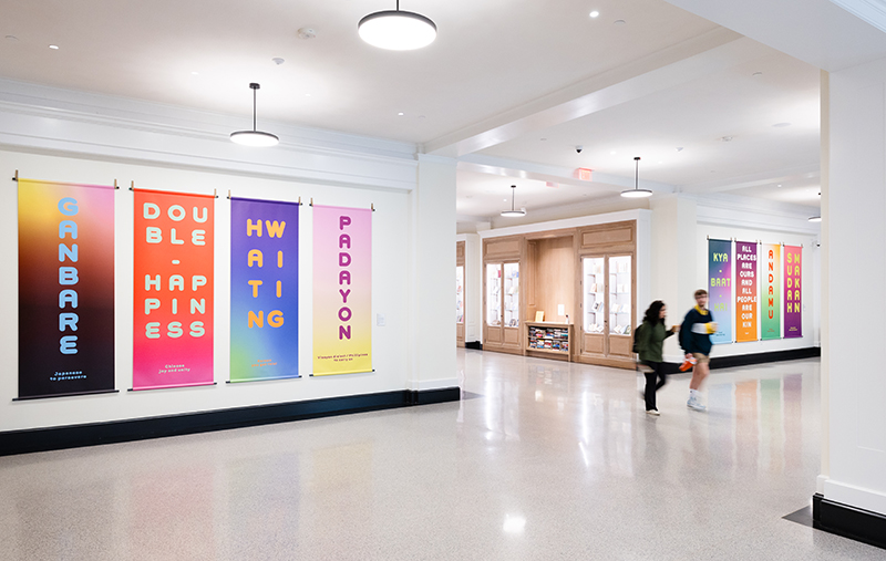 Eight colorful banners hang in a lobby area of the library.