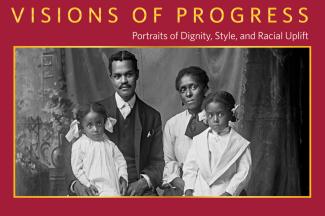 A black-and-white photograph shows a portrait of a Black family of four in a studio setting